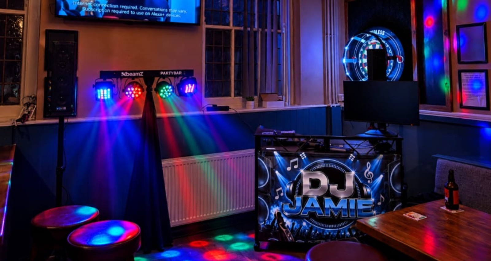 Coloured party lights over the DJ Jamie booth