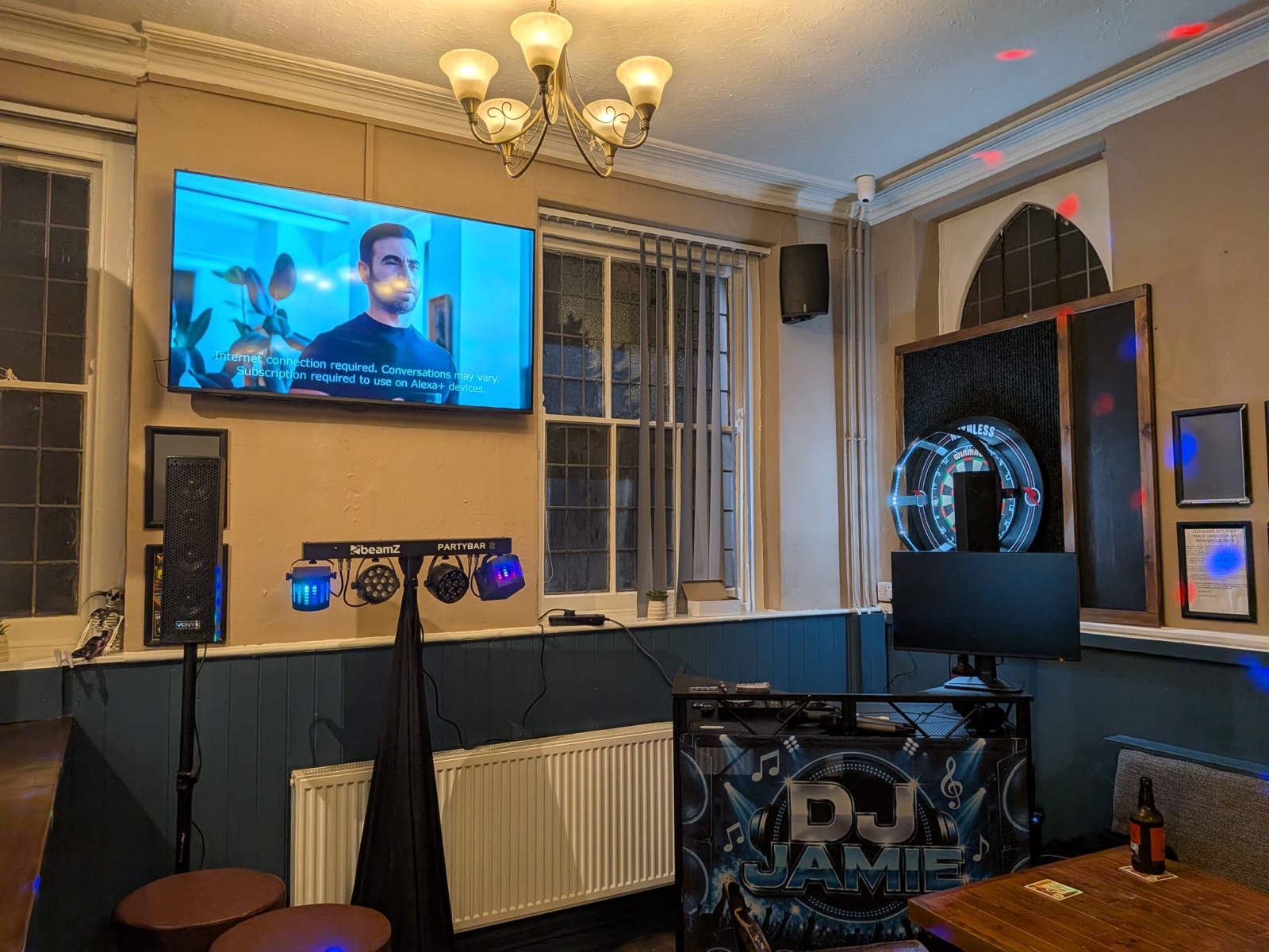 DJ setup with light bar and speaker in a pub